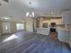 Bright, open-concept living space featuring modern lighting and durable gray flooring throughout at 15 Locust Trak, Ocala, FL 34472