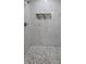Close up of a bathroom shower featuring a decorative accent niche and stone tile flooring at 15 Locust Trak, Ocala, FL 34472