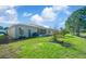 Expansive backyard featuring well-maintained lawn, mature trees, and lush landscaping for outdoor enjoyment at 15092 Sw 14Th Avenue Rd, Ocala, FL 34473