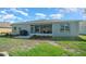 Spacious backyard with a screened lanai, lush lawn, and well-maintained landscaping for outdoor entertaining at 15092 Sw 14Th Avenue Rd, Ocala, FL 34473