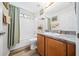 Well-lit bathroom featuring a tub with shower, vanity with updated countertop, and wood-look flooring at 15092 Sw 14Th Avenue Rd, Ocala, FL 34473