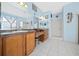 Here is a spacious primary bathroom with double sinks, wood cabinets, and a large walk-in shower at 15092 Sw 14Th Avenue Rd, Ocala, FL 34473