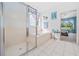 Bright bathroom featuring a glass-enclosed shower and a soaking tub, creating a serene and spa-like atmosphere at 15092 Sw 14Th Avenue Rd, Ocala, FL 34473