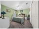 Comfortable bedroom featuring carpet, ceiling fan, and ample natural light at 15092 Sw 14Th Avenue Rd, Ocala, FL 34473
