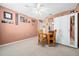 Carpeted bedroom featuring a ceiling fan, wood furniture, and a built-in wardrobe with mirrored door at 15092 Sw 14Th Avenue Rd, Ocala, FL 34473