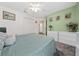 This primary bedroom features white trim, a ceiling fan, and a relaxing wall color at 15092 Sw 14Th Avenue Rd, Ocala, FL 34473
