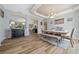 Bright dining room features stylish wood floors, chandelier lighting, and seating for six at 15092 Sw 14Th Avenue Rd, Ocala, FL 34473