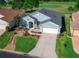 Inviting home featuring a well manicured lawn and landscaping, paired garage, and covered porch at 15092 Sw 14Th Avenue Rd, Ocala, FL 34473