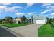 Charming single-story home featuring a well-manicured lawn, beautiful landscaping, and a light blue exterior at 15092 Sw 14Th Avenue Rd, Ocala, FL 34473