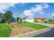 Charming blue home with well-manicured lawn, rock garden and attached two-car garage at 15092 Sw 14Th Avenue Rd, Ocala, FL 34473