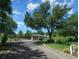 Gated community entrance with brick-paved road, mature trees, and professional landscaping, enhancing security and appeal at 15092 Sw 14Th Avenue Rd, Ocala, FL 34473