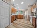 Well-lit kitchen with stainless steel appliances and wood laminate flooring at 15092 Sw 14Th Avenue Rd, Ocala, FL 34473