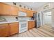 Kitchen featuring wood cabinets, stainless steel refrigerator, and wood-look flooring at 15092 Sw 14Th Avenue Rd, Ocala, FL 34473