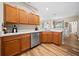 Kitchen features stainless steel appliances, wood cabinets, white countertops and wood-look flooring at 15092 Sw 14Th Avenue Rd, Ocala, FL 34473