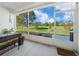 Relaxing screened lanai offers beautiful views of the lush green lawn, trees, and a bright blue sky at 15092 Sw 14Th Avenue Rd, Ocala, FL 34473