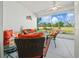 Relaxing screened-in patio with comfortable seating, ceiling fan and view of the lush golf course at 15092 Sw 14Th Avenue Rd, Ocala, FL 34473