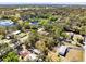 Wide aerial shot showcases the property near a pond and surrounding neighborhood with lush greenery at 1533 Pine St, Apopka, FL 32703