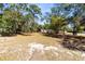 Spacious backyard with mature trees providing plenty of shade and a serene, natural setting at 1533 Pine St, Apopka, FL 32703