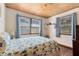 Bedroom features hardwood floors, wood ceiling, and ample natural light with a comfy bed at 1533 Pine St, Apopka, FL 32703