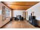 Bright bedroom features hardwood floors, wood ceiling, and natural light from the large windows at 1533 Pine St, Apopka, FL 32703