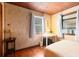 Comfortable bedroom with wood floors, wall paper, wood ceiling and natural light at 1533 Pine St, Apopka, FL 32703