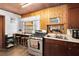 Bright kitchen featuring stainless steel appliances, wooden countertops, and overhead cabinets at 1533 Pine St, Apopka, FL 32703