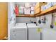 Clean laundry room with side by side washer and dryer and ample storage space at 1533 Pine St, Apopka, FL 32703