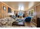 Spacious living room featuring wood paneling and multiple sitting areas at 1533 Pine St, Apopka, FL 32703