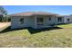 Spacious backyard featuring a covered patio and sliding glass doors, perfect for outdoor enjoyment at 2722 Sw 151St Ave, Ocala, FL 34481