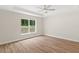 Bright bedroom with a ceiling fan, large window, and wood-look flooring at 2722 Sw 151St Ave, Ocala, FL 34481