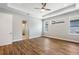 Spacious bedroom featuring wood floors, tray ceiling, and natural light from multiple windows at 2735 Se 19Th Ct, Ocala, FL 34471