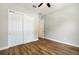 Bedroom with hardwood floors, ceiling fan, and closet with sliding doors at 2735 Se 19Th Ct, Ocala, FL 34471