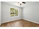 Bright bedroom featuring wood floors and a large window with green views at 2735 Se 19Th Ct, Ocala, FL 34471