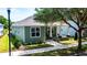 Charming green home with white trim, inviting front porch with pillars, and well-maintained landscaping at 2735 Se 19Th Ct, Ocala, FL 34471