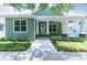 Charming green home with a welcoming front porch and manicured landscaping at 2735 Se 19Th Ct, Ocala, FL 34471