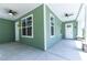 Spacious covered front porch with ceiling fans and views of the neighborhood at 2735 Se 19Th Ct, Ocala, FL 34471