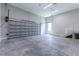 Spacious garage with concrete floors, bright lighting, and stairs to upper level at 2735 Se 19Th Ct, Ocala, FL 34471