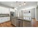 Kitchen island featuring stone countertops, stainless dishwasher, and custom cabinets at 2735 Se 19Th Ct, Ocala, FL 34471