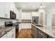 Kitchen featuring stainless steel appliances, granite countertops, custom cabinets and wood-look floors at 2735 Se 19Th Ct, Ocala, FL 34471