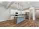 Bright kitchen features a center island, granite countertops, stainless steel appliances, and wood grain tile flooring at 2735 Se 19Th Ct, Ocala, FL 34471