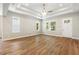 Bright living room featuring hardwood floors, tray ceiling, and lots of natural light at 2735 Se 19Th Ct, Ocala, FL 34471