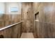 Elegant tile shower featuring decorative niche, glass partition, and modern fixtures at 2735 Se 19Th Ct, Ocala, FL 34471
