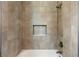 Close up of shower with tile surround and a recessed niche at 2735 Se 19Th Ct, Ocala, FL 34471