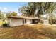 Home exterior with a paver patio and metal storage shed with views of the wooded backyard at 3380 Ne 42Nd Pl, Ocala, FL 34479