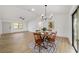 Dining room featuring hardwood floors, chandelier lighting, and a sliding glass door to outdoors at 3380 Ne 42Nd Pl, Ocala, FL 34479