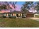 Charming one-story home featuring a classic design, well-manicured lawn, and a two-car garage at 3380 Ne 42Nd Pl, Ocala, FL 34479