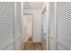 Hallway with closet doors and views into bathroom and other rooms at 3380 Ne 42Nd Pl, Ocala, FL 34479