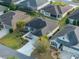 Aerial view showcases a single Gathering home featuring landscaped front yard, long driveway and a two car garage at 3407 Melbourne Ln, The Villages, FL 32163