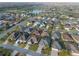Expansive aerial view of a single Gathering home, showcasing the surrounding neighborhood and landscape at 3407 Melbourne Ln, The Villages, FL 32163