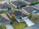 High angle view of a single Gathering home with manicured lawn and a long drive leading to a two car garage at 3407 Melbourne Ln, The Villages, FL 32163